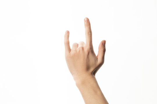 Male hand close-up on a white background shows hand gesture. Rock'n'roll. Isolate.