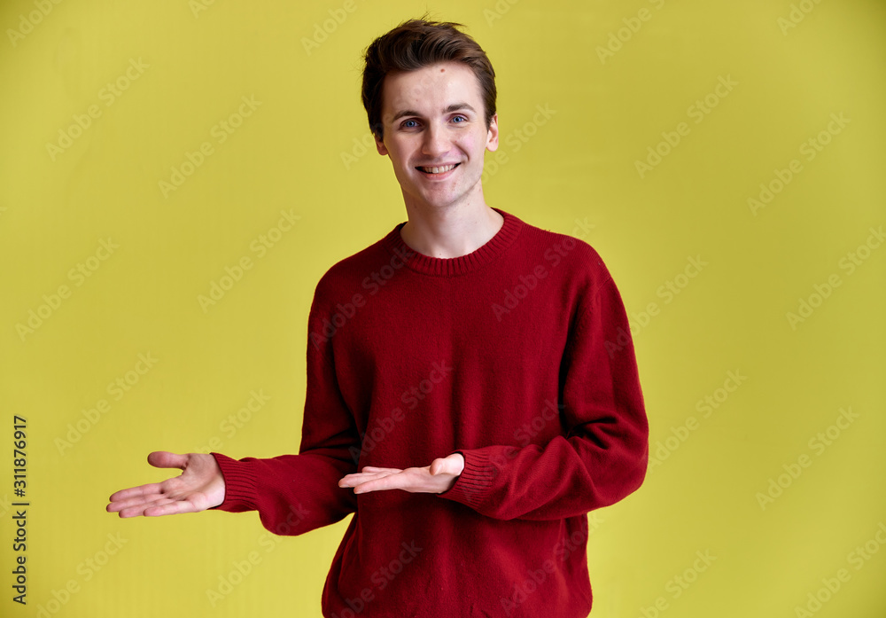 Wall mural portrait of a handsome young man with a wide smile. caucasian short-haired man in a burgundy sweater