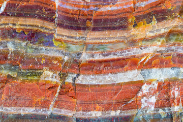 A large piece of raw agate. The semi-precious stone is banded and shows many, intense colors. Concept: rocks and minerals