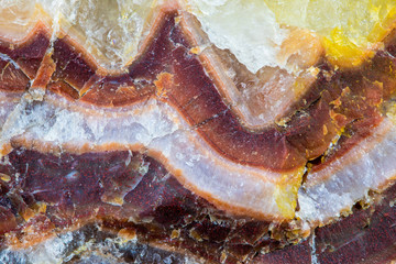 A large piece of raw agate. The semi-precious stone is banded and shows many, intense colors....