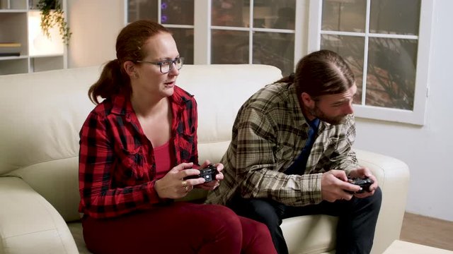 Woman pushing boyfriend after their loss while playing video games