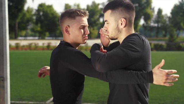 Two fighters practice mma skills in training