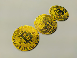 Closeup and side view of bitcoins golden coins symbolizing the modern digital cryptocurrencies used...