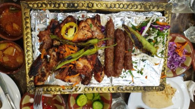 Eating barbecue in Egypt Middle East grill food beef and chicken serve with side dishes