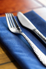 Knife and fork on a blue napkin, closeup