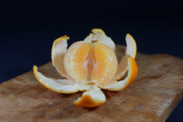 Pieces of mandarin in the remaining peel close up