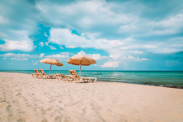 Beach chairs on tropical vacation, travel to sea concept