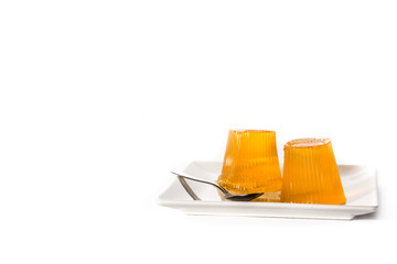 Orange jellies on a plate isolated on white background. Copy space