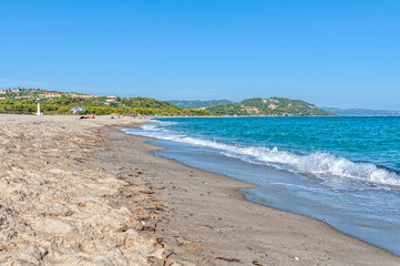 Fototapeta na wymiar Halkidiki, Greece - September 01,2019: Possidi Beach on Halkidiki, Greece. Blue sea on Aegean sea. Possidi lighthouse. 