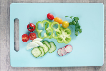 Colorful vegetables on cutting board with copy space