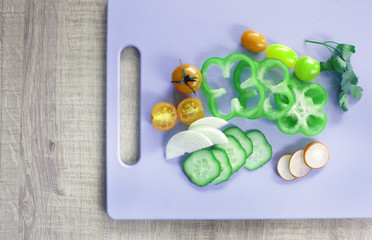 Colorful vegetables on cutting board with copy space