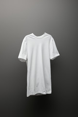 blank basic white t-shirt on grey background