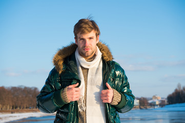 Posing for photo. handsome guy green puffer coat. man enjoy sunny winter day. male seasonal...