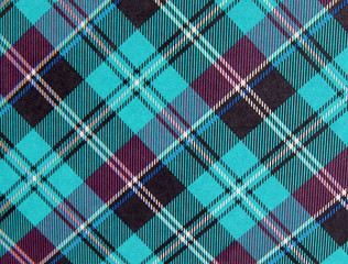 Plaid background pattern in turquoise and purple with black, white and blue