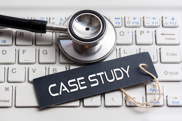 CASE STUDY word written on label with stethoscope and white keyboard