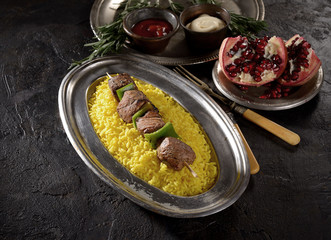 kebab with rice on a dark background