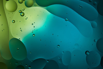 creative abstract background from mixed water and oil in blue and green color