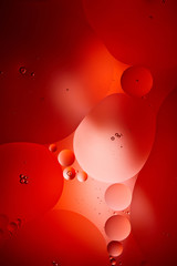 creative abstract red color background from mixed water and oil bubbles