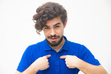 Confident ambitious guy pointing fingers at himself. Handsome bearded young man in blue casual...
