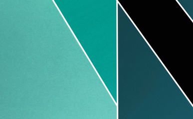 Layers of colored, rough textured construction paper creating a graphic template. Abstract design geometric style color blocks. Copyspace. Teal and black