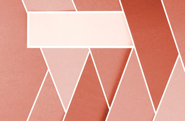 Layers of colored, rough textured construction paper creating a graphic template. Abstract design geometric style color blocks. Copyspace. Shades of coral and blush