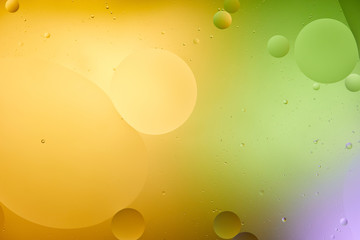 Beautiful orange, purple and green color abstract background from mixed water and oil