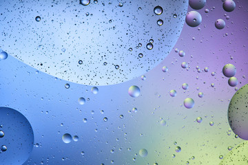 Beautiful abstract background from mixed water and oil in blue, purple and green color