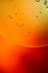 abstract background from mixed water and oil bubbles in red color