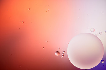 abstract background from mixed water and oil bubbles in red and purple color