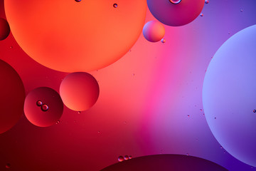 creative abstract background from mixed water and oil bubbles in pink and purple color