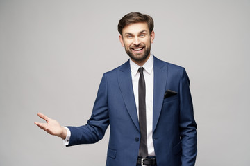 Portrait of a young businessman pointing on a copyspace with his finger