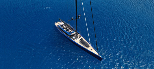 Aerial drone ultra wide photo of luxury sail boat cruising the Aegean deep blue open sea
