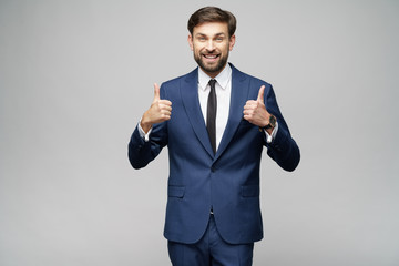 young business man going thumb up on grey background