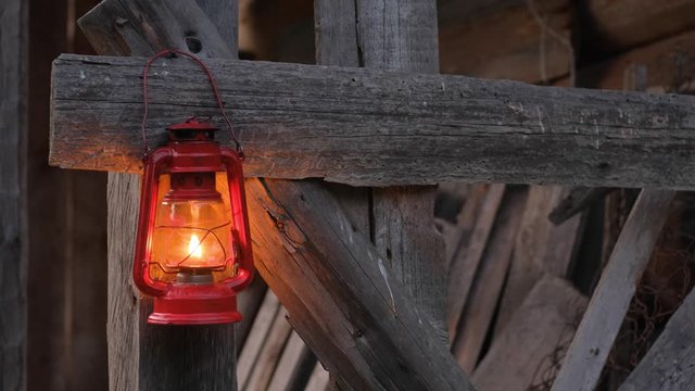 Close up of red  kerosene lamp on the wooden wall