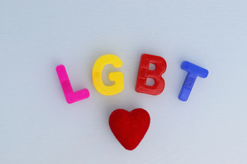 LGBT community symbol on a white background and red heart. Human rights, equality. Sign for lesbians, gays, bisexuals and transgender people.  LGBT concept. Copyspace for text.