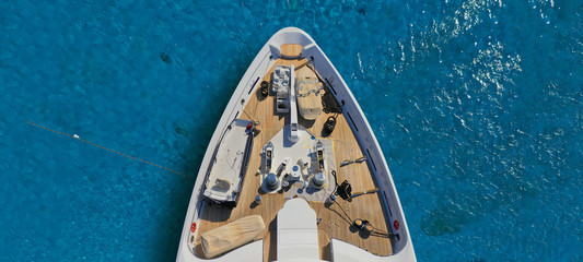 Aerial drone ultra wide photo of luxury yacht with wooden deck docked in tropical exotic destination