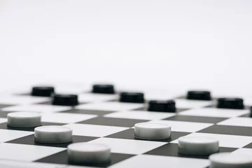 Foto op Canvas Selective focus of checkers on chessboard isolated on white © LIGHTFIELD STUDIOS