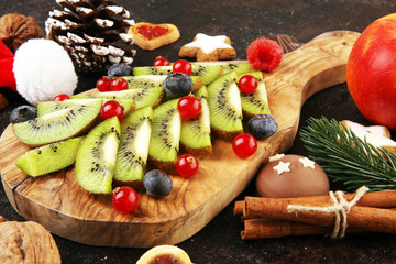 Funny edible Christmas tree, Christmas breakfast idea for kids. Beautiful Christmas and New Year food background with fruits