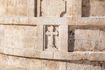 A large stone cross carved from stone on the St. Nicholas church in Bay Jala - a suburb of...
