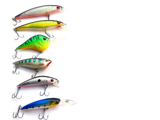 Voblers isolated on a white background. Composition of voblers. Set of voblers. Set of fish lures with hooks. The composition of the fisherman. Set of lures for spinning. Plastic fish with hooks.  © serega_100500