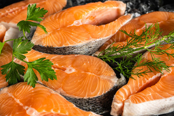 Salmon steaks on ice with herbs