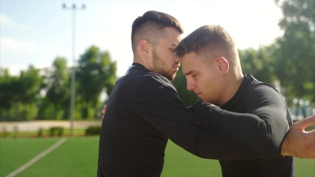 Two fighters practice mma skills in training