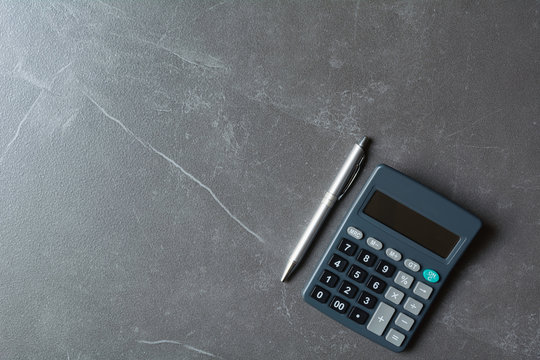 Close up of black calculator with pen and copy space. Technology and financial concept.