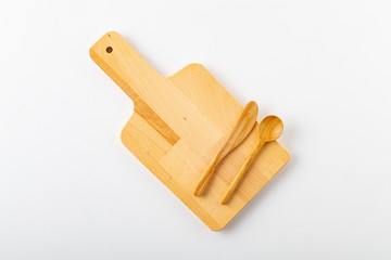Woody cutting board, spoon and fork