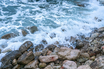 Aerial view of a coast in a cove, waves crashing against the rocks in a stormy day, fury of the sea in Majorca, Balearic Islands, Spain.