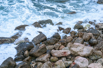 Aerial view of a coast in a cove, waves crashing against the rocks in a stormy day, fury of the sea in Majorca, Balearic Islands, Spain.
