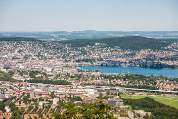 Fototapeta premium Panorama of the of old downtown of Zurich city, with beautiful house at the bank of Lake of Zurich. Aerial view from the the top of Mount Uetliberg