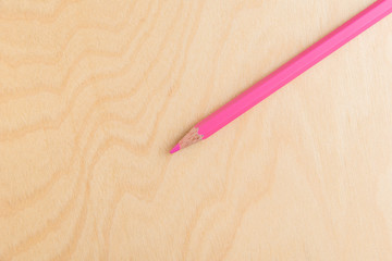 Pink Color Pencil Isolated On Wood Background