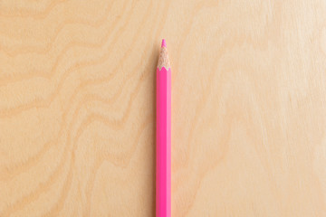 Pink Color Pencil Isolated On Wood Background