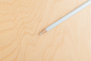 White Color Pencil Isolated On Wood Background